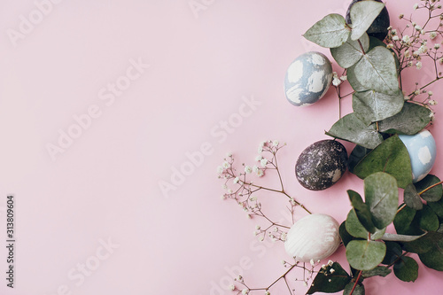 Photography Stylish easter eggs,spring flowers, eucalyptus branch on pink paper flat lay, space for text