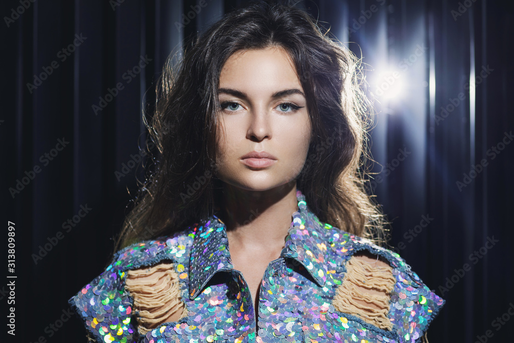 Sexy woman wearing stylish shimmering jacket covered with a lot of sequins