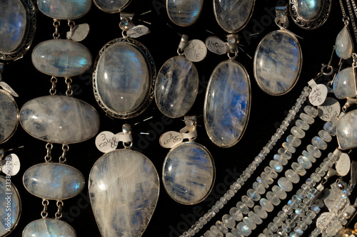 Tableau sur toile Rainbow moonstone necklage earrings jewelry on display stand in a shop market