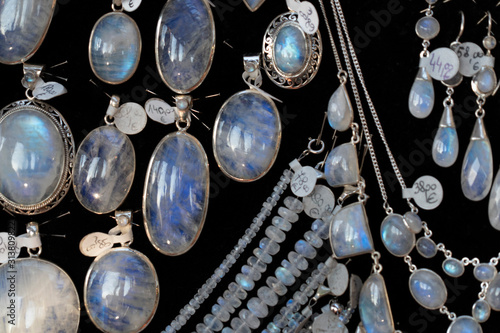 Rainbow moonstone necklage earrings jewelry on display stand in a shop market photo