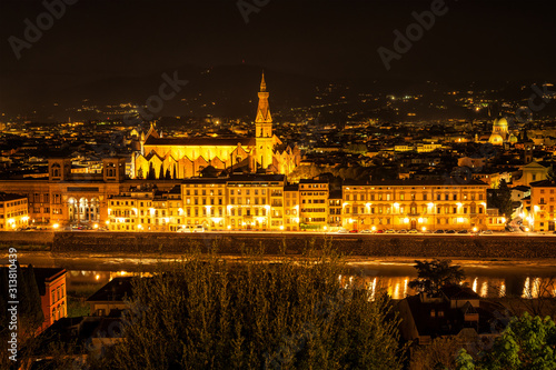 Florence, Italy - April 7, 2019: Amazing night view of Florence city, Italy with the river Arno and Basilica of Santa Croce.