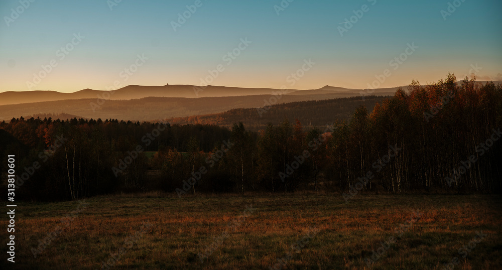 sunrise on the meadow with hills in background sunrise on the meadow with hills in background