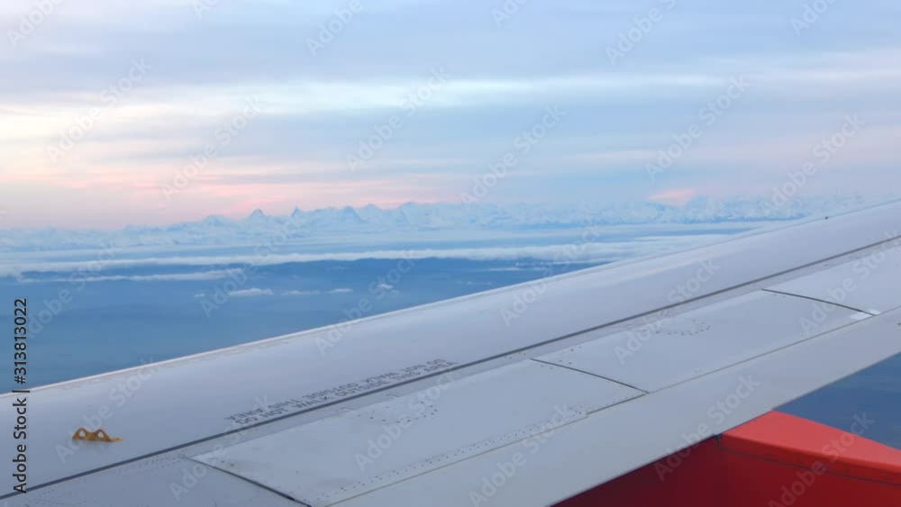 View of swiss alps from plane passenger window View of swiss alps from plane passenger window