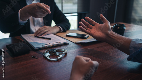 фотографія police officer presenting evidence to suspect after committed a crime, investigation and interrogation concepts