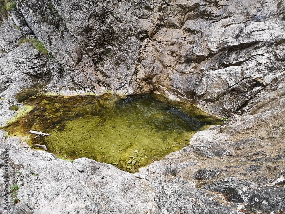 Little green yellow lake in the mountains