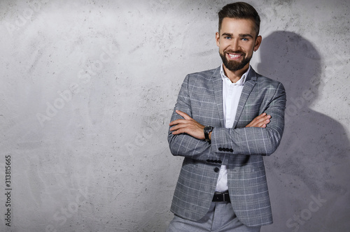 Handsome bearded man wearing gray checkered suit