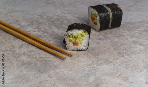 closeup sushi rolls with chopsticks on the table. Japanese food.