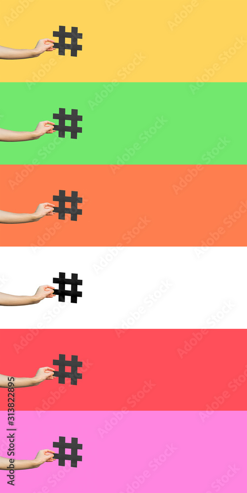 Social media concept. closeup of human hand holding and showing large big black hashtag sign. indoor studio shot, isolated on different colorful background copyspace. marketing symbol. - obrazy, fototapety, plakaty 