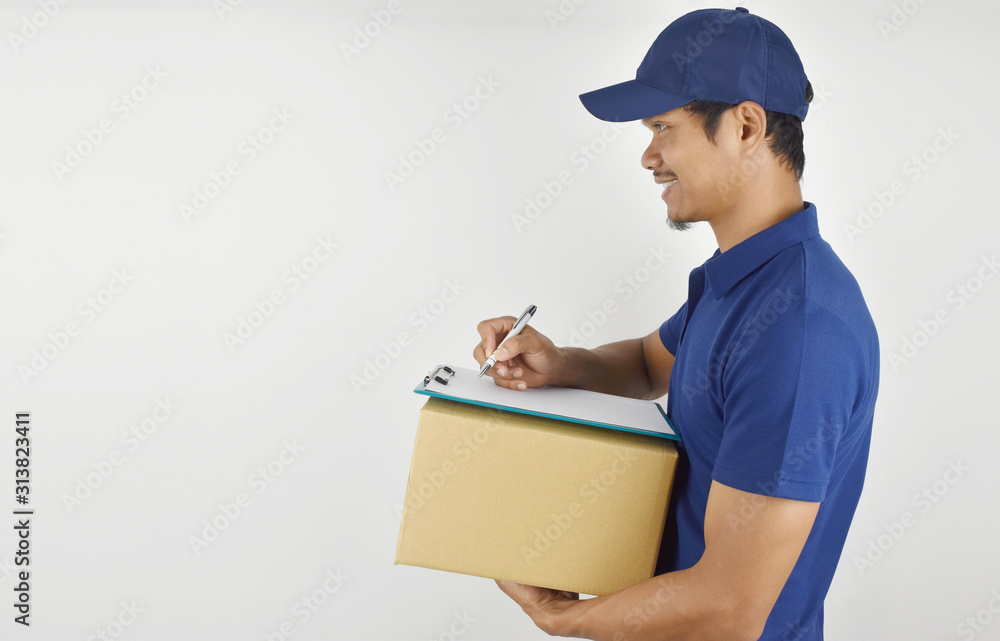 Delivery concept. portrait of delivery man holding parcel box for customer services and writing customer list on a clipboard on white background. Delivery concept. portrait of delivery man holding parcel box for customer services and writing customer list on a clipboard on white background.