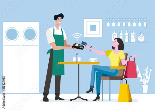 Woman paying contactless with credit card to a male waiter
