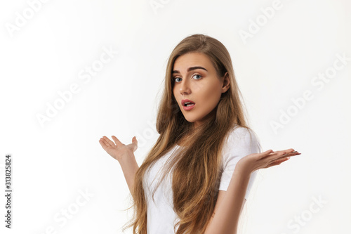 Portrait of young surprised beautiful woman with shocked facial expression on white background