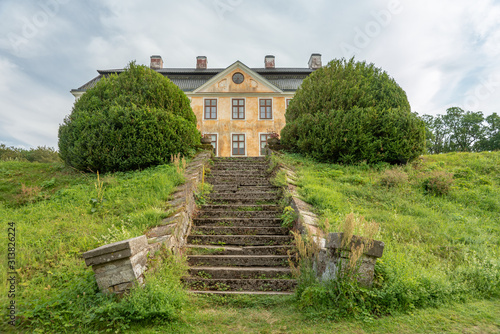 Skewed and warped stair leading to a rundown castle in Sweden photo