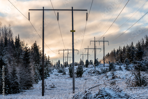 High voltage power lines in a sunny winter land in Sweden