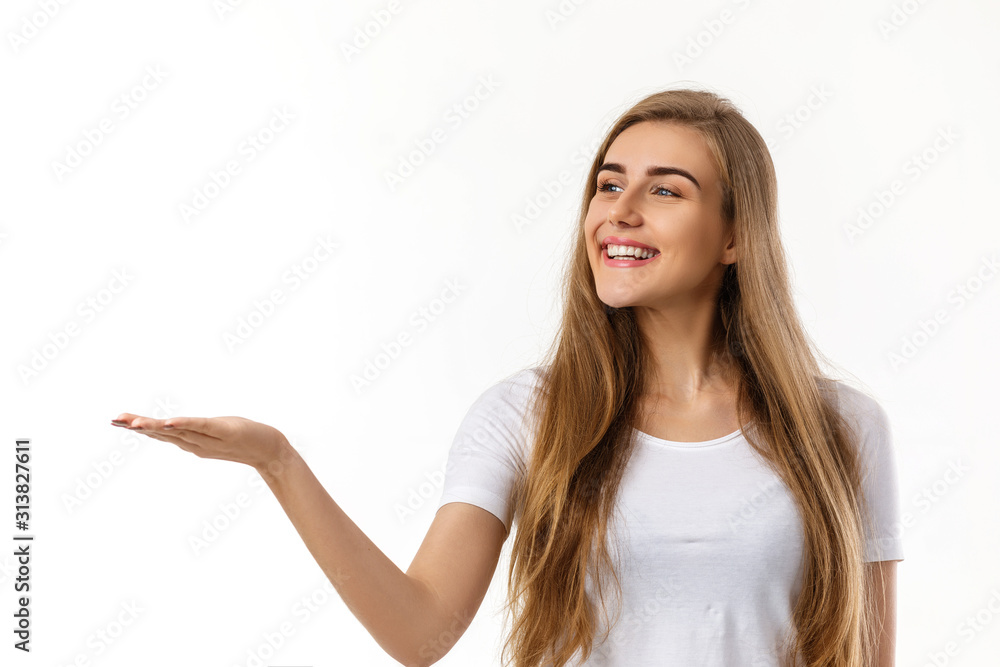 smiling young woman showing copyspace pointing on white background. smiling young woman showing copyspace pointing on white background.
