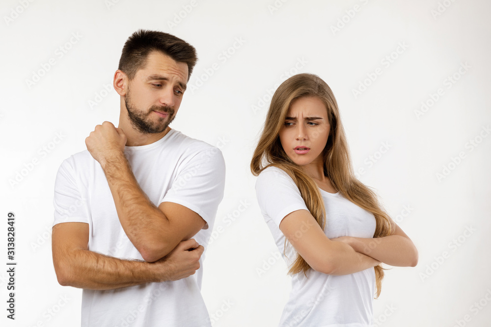 couple argued and resent each other. young woman and her boyfriend standing on white background couple argued and resent each other. young woman and her boyfriend standing on white background