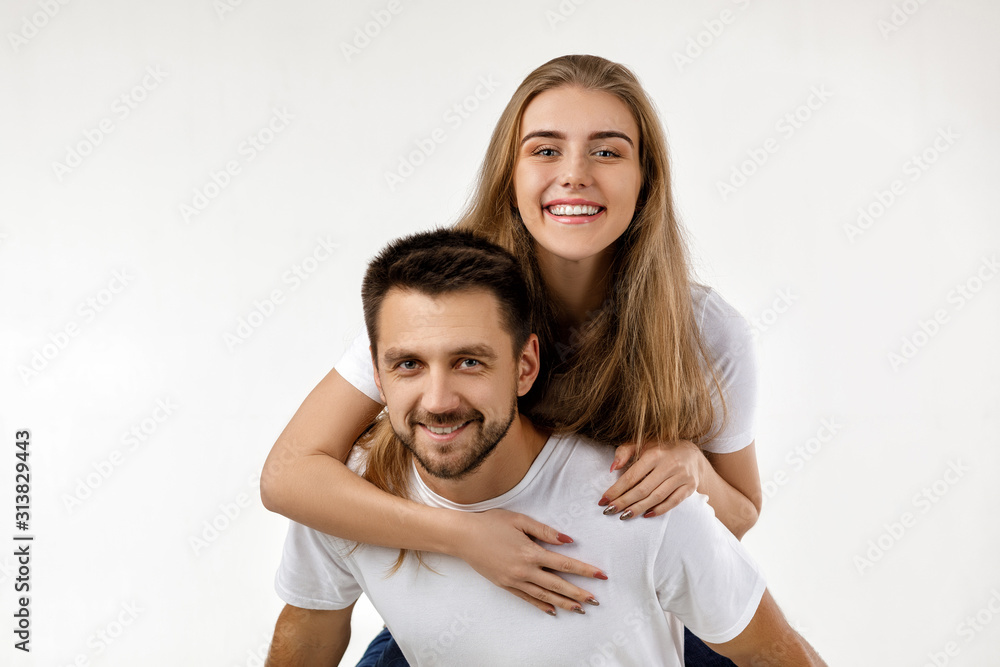 beautiful happy couple in love are hugging and looking at camera on white background. st valentines day beautiful happy couple in love are hugging and looking at camera on white background. st valentines day