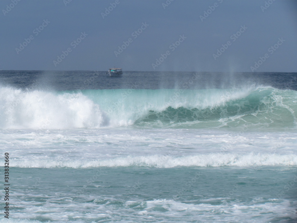 Fishing boat operating beyond the breaking waves.