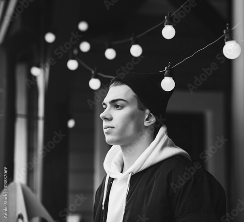 Canvas-taulu portrait of a cool man in a black hat in an urban setting