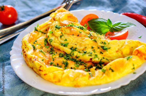 omelette in a white plate on wooden table photo