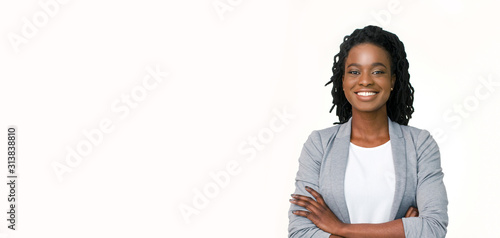 Confident afro businesswoman posing with folded arms on white background