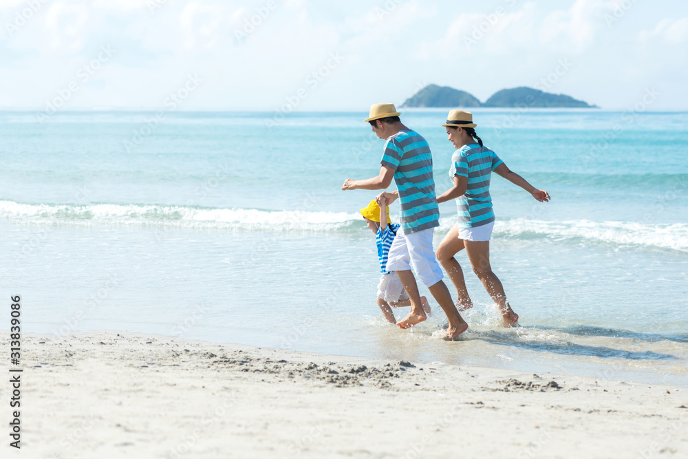 Asian happy family have fun and running relax on the beach for leisure and destination.  Family people tourism travel enjoy in summer and holiday.  Travel and Family Concept