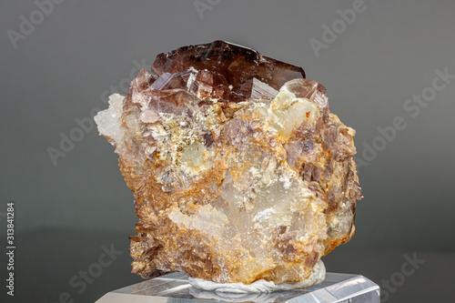 Macro minerals Axinite stone on a gray background photo