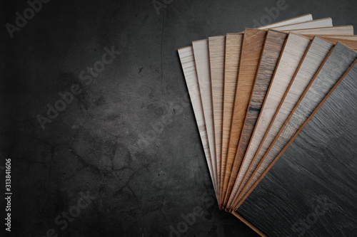 wood texture laminate material samples on black stone background with copy space photo