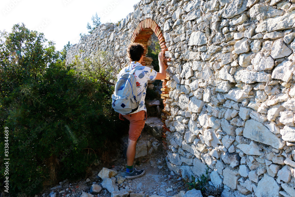 Fototapeta premium Young model walking through a door in southern france