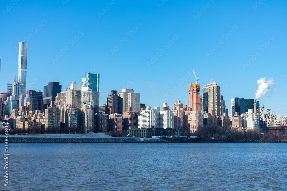 Midtown Manhattan Skyline along the East River in New York City with the Queensboro Bridge