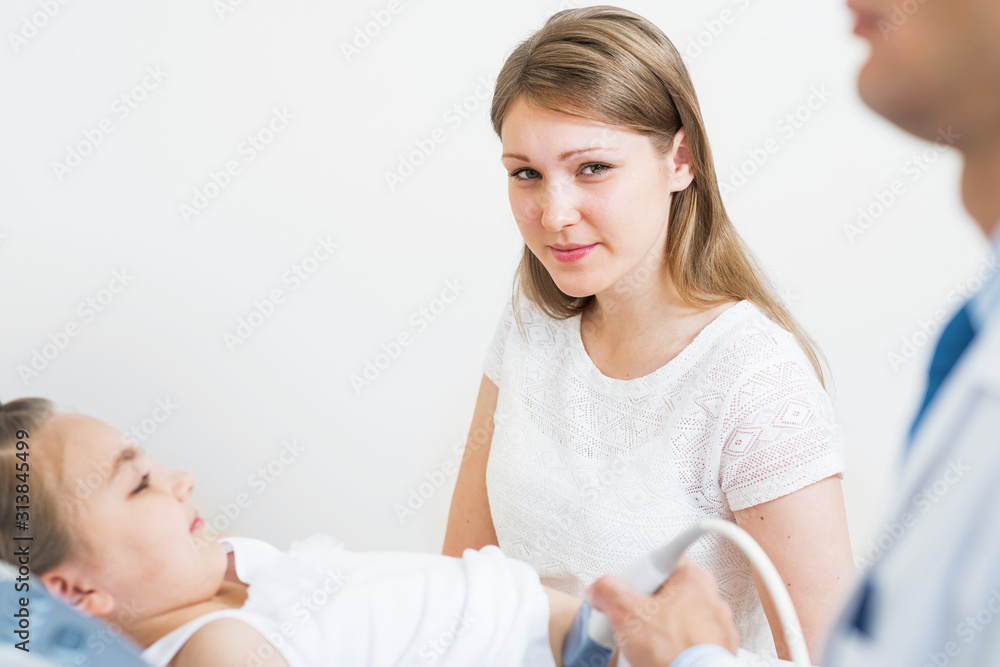 Doctor ultrasound examines little girl belly Doctor ultrasound examines little girl belly