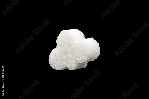 Refined sugar in cubes on a black background