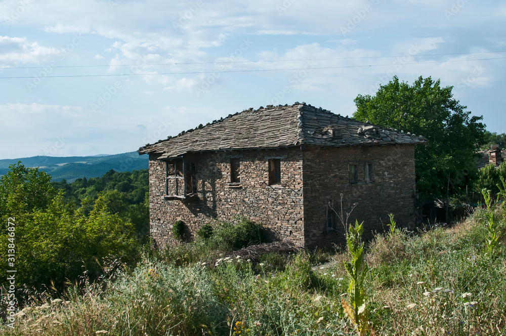 Old rural country stone house facade in sunny summer day Old rural country stone house facade in sunny summer day