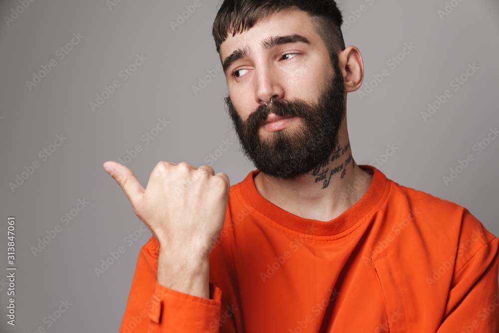Image closeup of young bearded man pointing finger at copyspace Image closeup of young bearded man pointing finger at copyspace