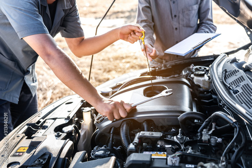 Technician team working of car mechanic in doing auto repair service and maintenance worker repairing vehicle with checking oil, Service and Maintenance car check