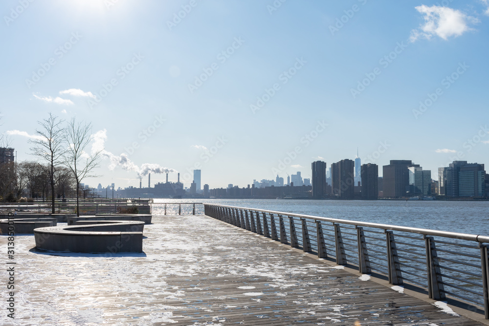 Waterfront with Benches along the East River in Long Island City Queens New York looking out towards the Manhattan Skyline