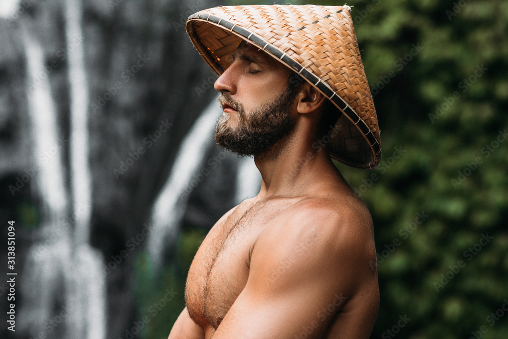 Portrait of a sports guy in an Asian conical hat. Portrait of a