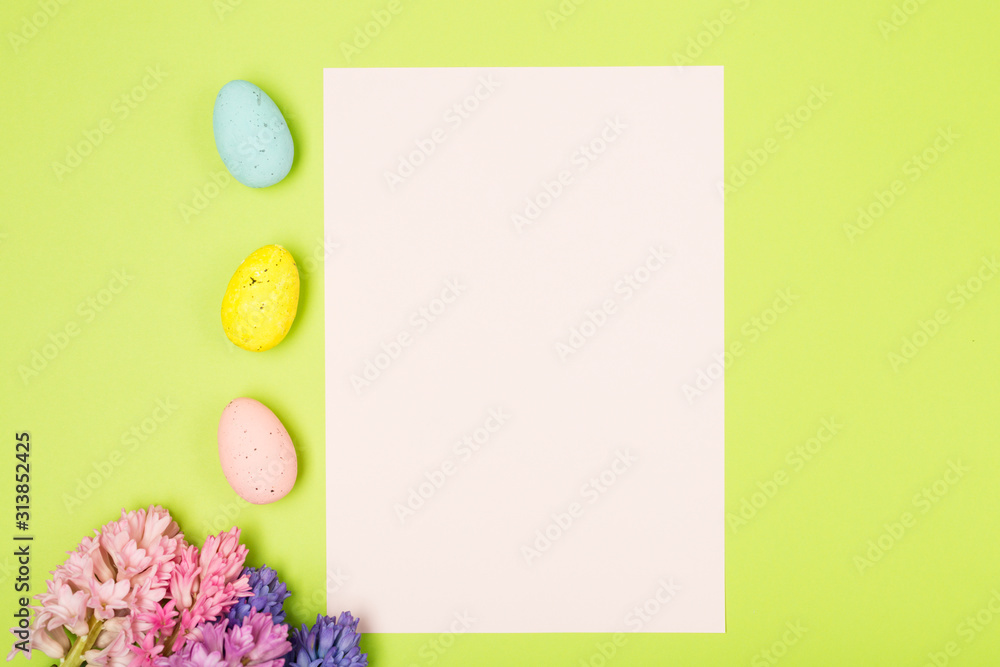 Easter composition with hyacinths, eggs, rabbit and blank paper. Background. Easter concept. Flat lay, moke up. 