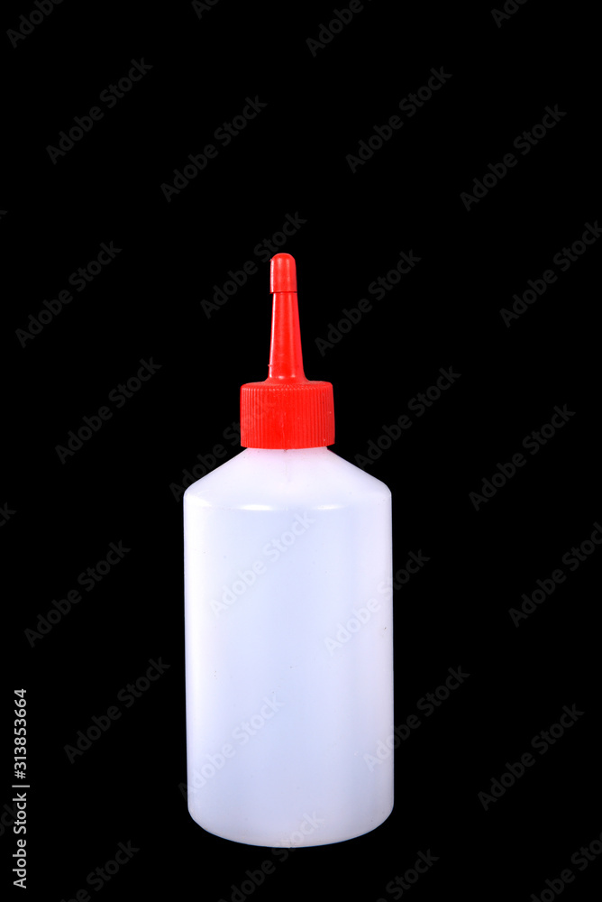 white plastic bottle with red spout isolated on black background white plastic bottle with red spout isolated on black background