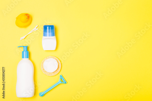 Woman Bath cleaning care morning routine top view flat lay composition with white, blue yellow items on yellow desk.