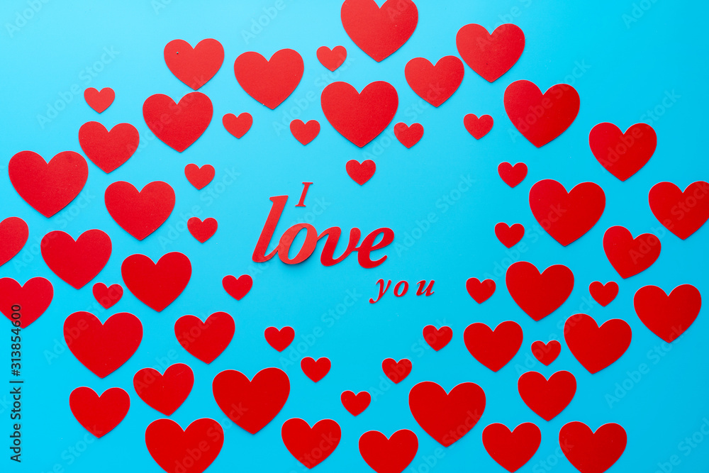 words i love you in the center. Template for the day of Saint Valentine and all lovers. red hearts on a blue background space words i love you in the center. Template for the day of Saint Valentine and all lovers. red hearts on a blue background space