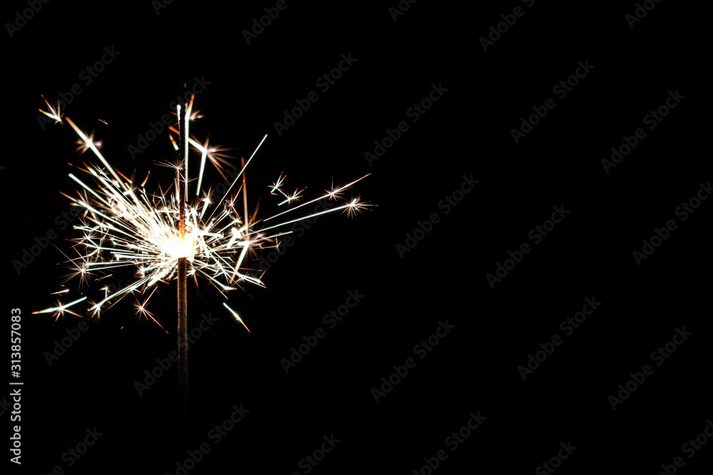 bright festive Christmas sparkler in hand toning bright festive Christmas sparkler in hand toning