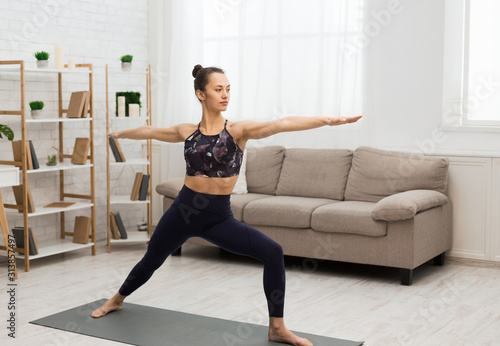 Yoga concept. Slim woman doing stretching exercise at home