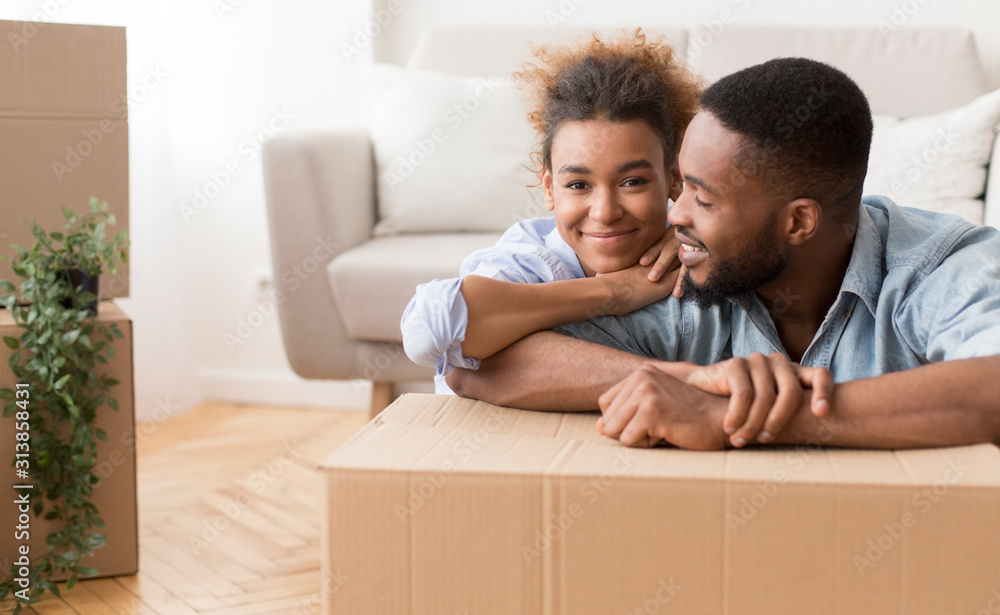 Couple Hugging Sitting On Floor Among Boxes In New Apartment Couple Hugging Sitting On Floor Among Boxes In New Apartment