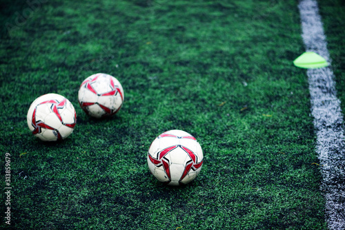 Training Balls in green soccer field