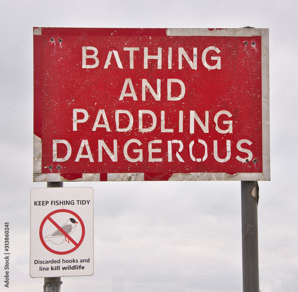 Fototapeta premium Warning and prohibition signs found along the beach at Hayling Island Hampshire UK