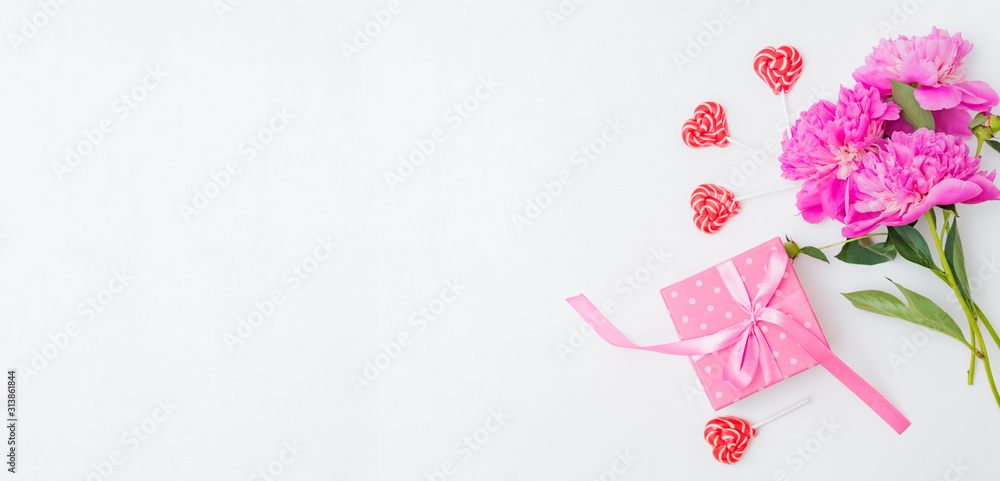 Flat lay valentines day frame with pink peonies and gift box on a white  background