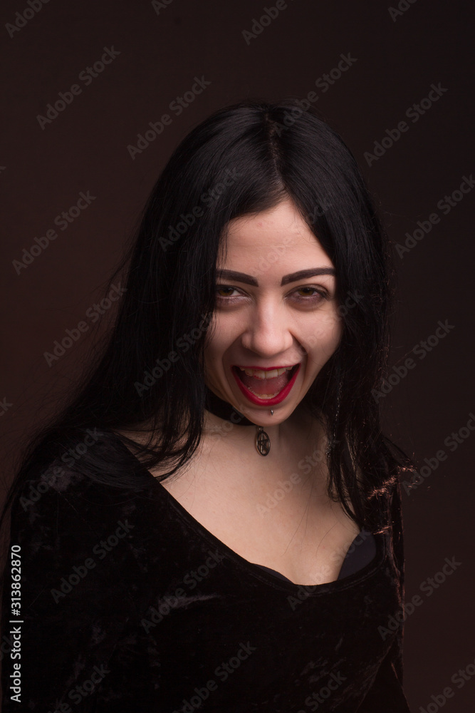 brunette on dark background dressed in goth style brunette on dark background dressed in goth style