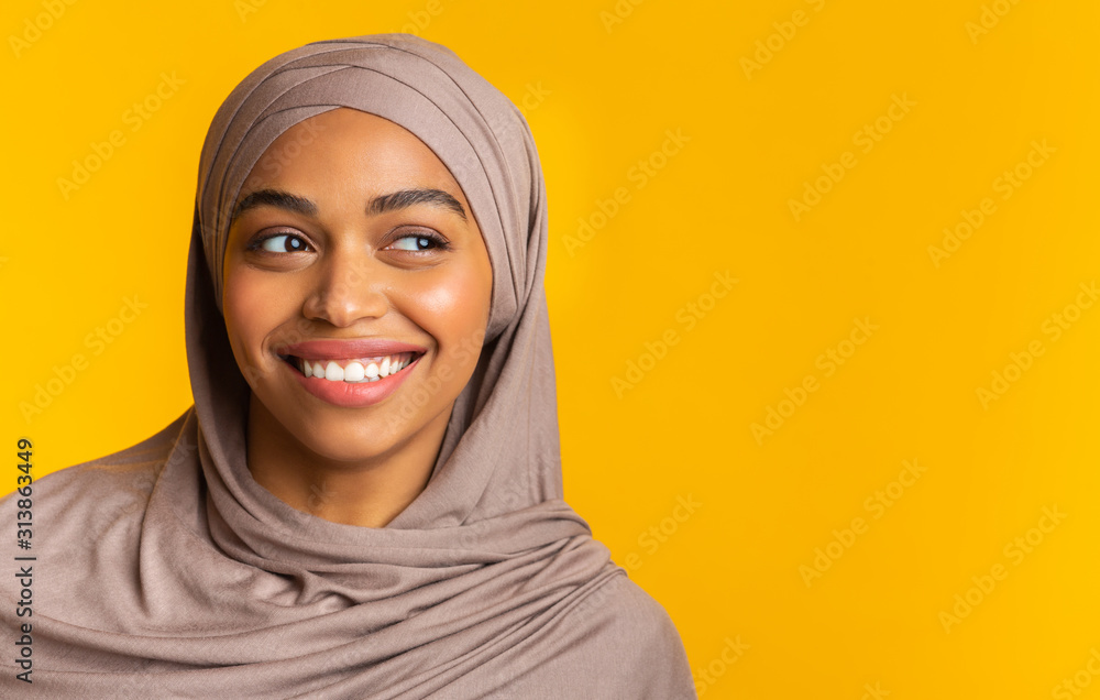 Beautiful black girl in hijab looking aside at copy space, closeup Beautiful black girl in hijab looking aside at copy space, closeup