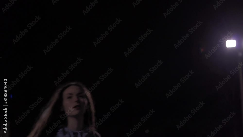 Epic slow motion shot of teenage girl shooting basketball at night outside, backlit. Epic slow motion shot of teenage girl shooting basketball at night outside, backlit.