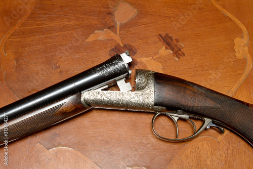 Beautiful hunting gun on vintage wooden background